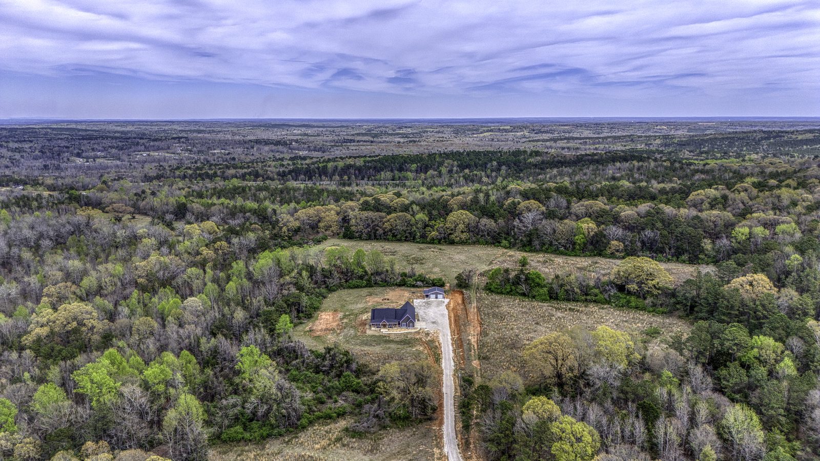 The Stone Craftsman high aerial of the property and surrounding land