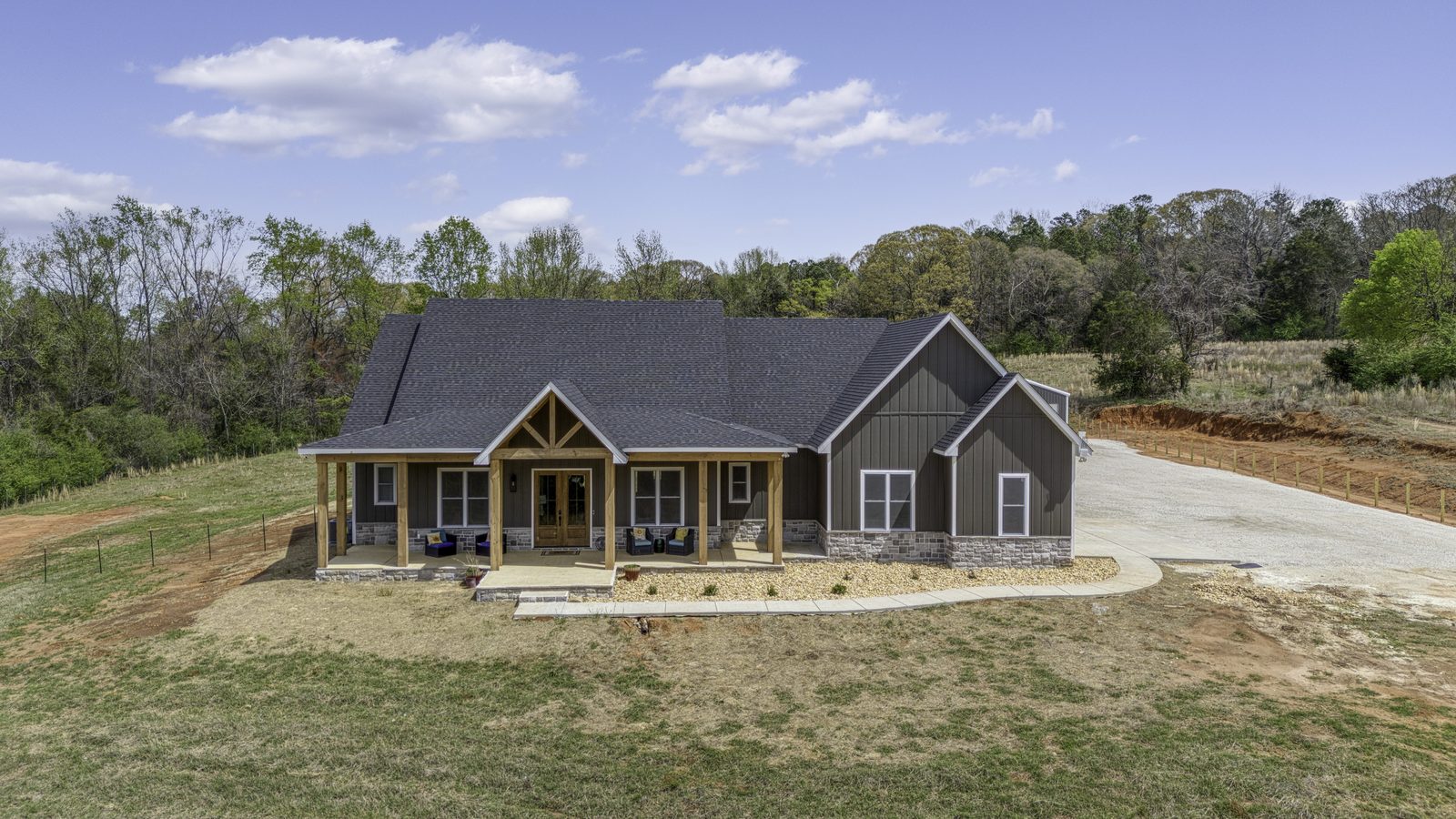 The Stone Craftsman front aerial view of the craftsman home and porch