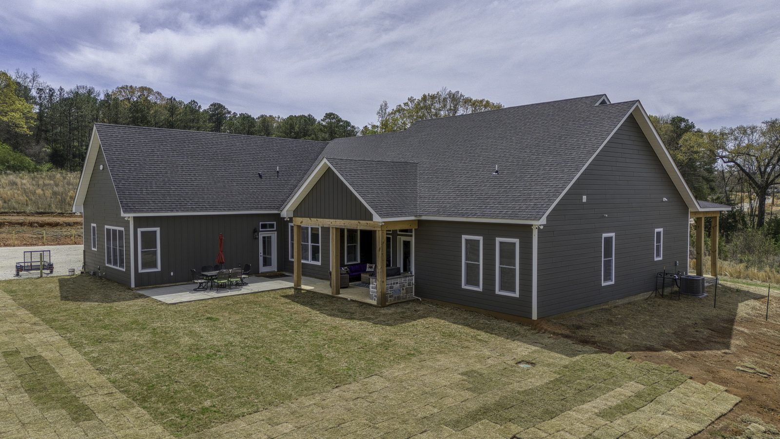 The Stone Craftsman rear view of the home with covered back porch