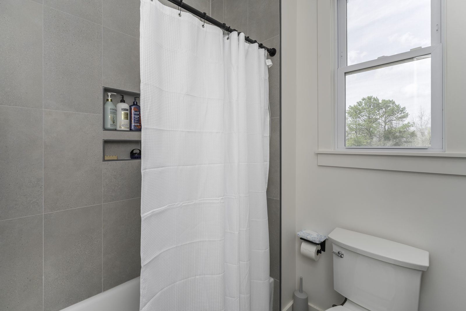 The Stone Craftsman bathroom with tub and shower