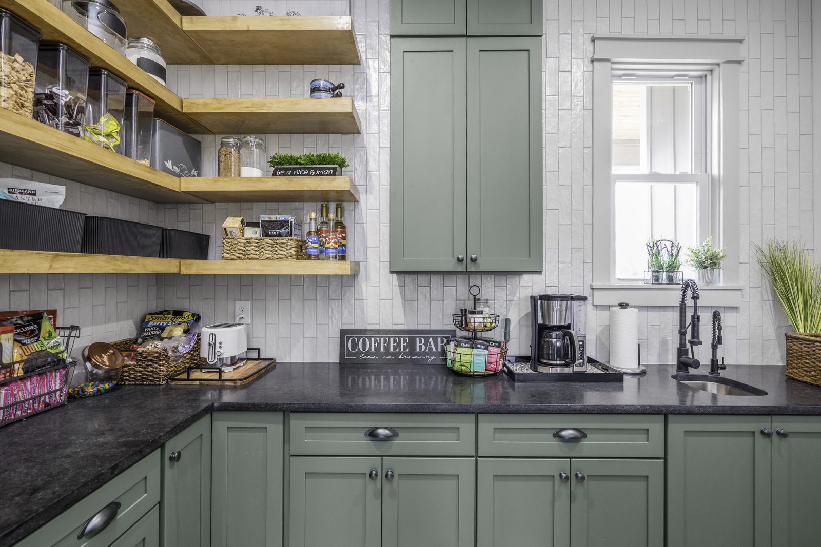 The Stone Craftsman green-cabinet coffee bar and pantry with open wood shelves