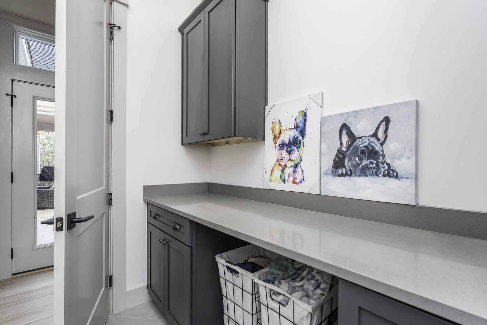 The Stone Craftsman laundry room with cabinets and folding counter