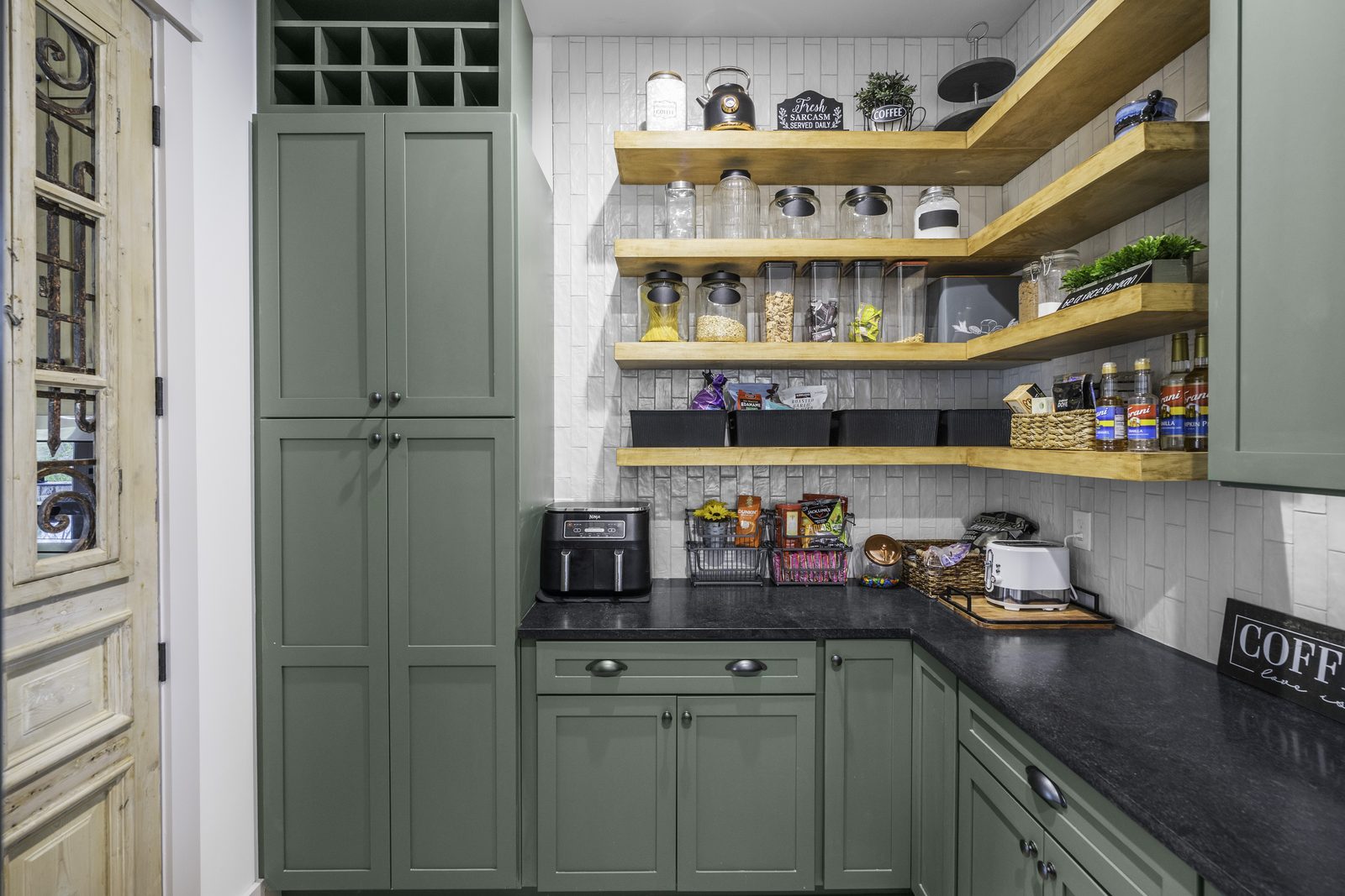 The Stone Craftsman green-cabinet pantry with open wood shelving