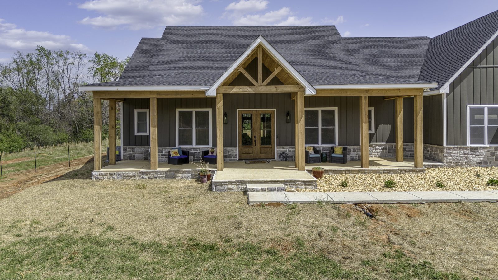 The Stone Craftsman front porch with cedar posts and stone skirting