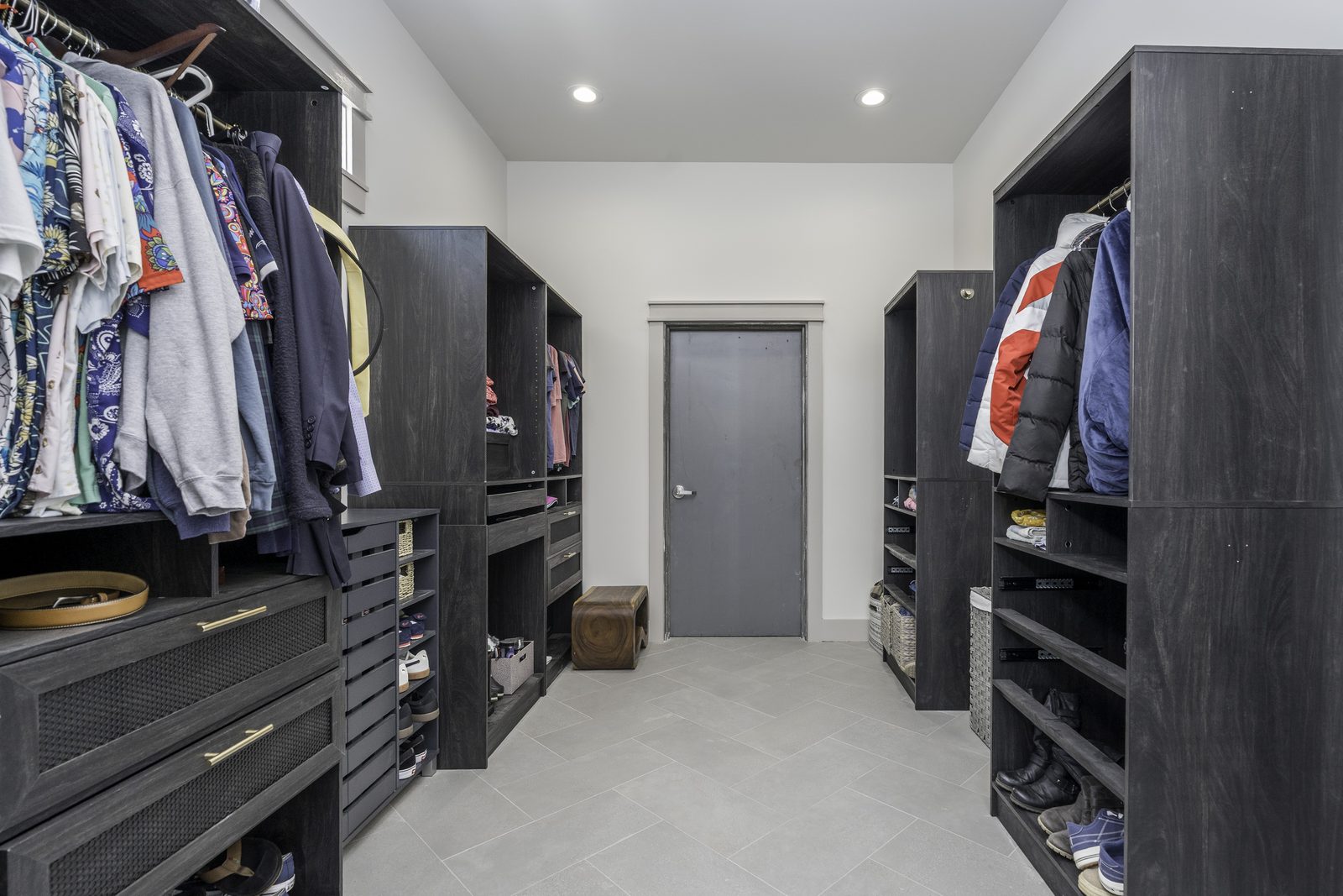 The Stone Craftsman primary walk-in closet with built-in shelving