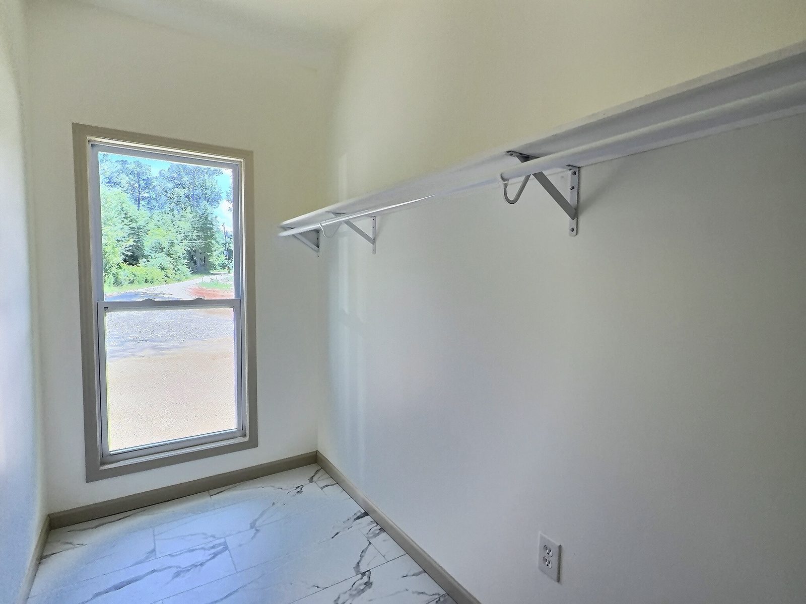 The Cedar Ranch primary walk-in closet with window