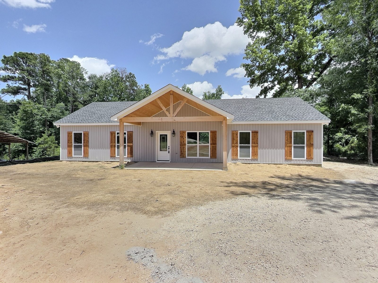 The Cedar Ranch exterior with cedar gable porch and cedar shutters