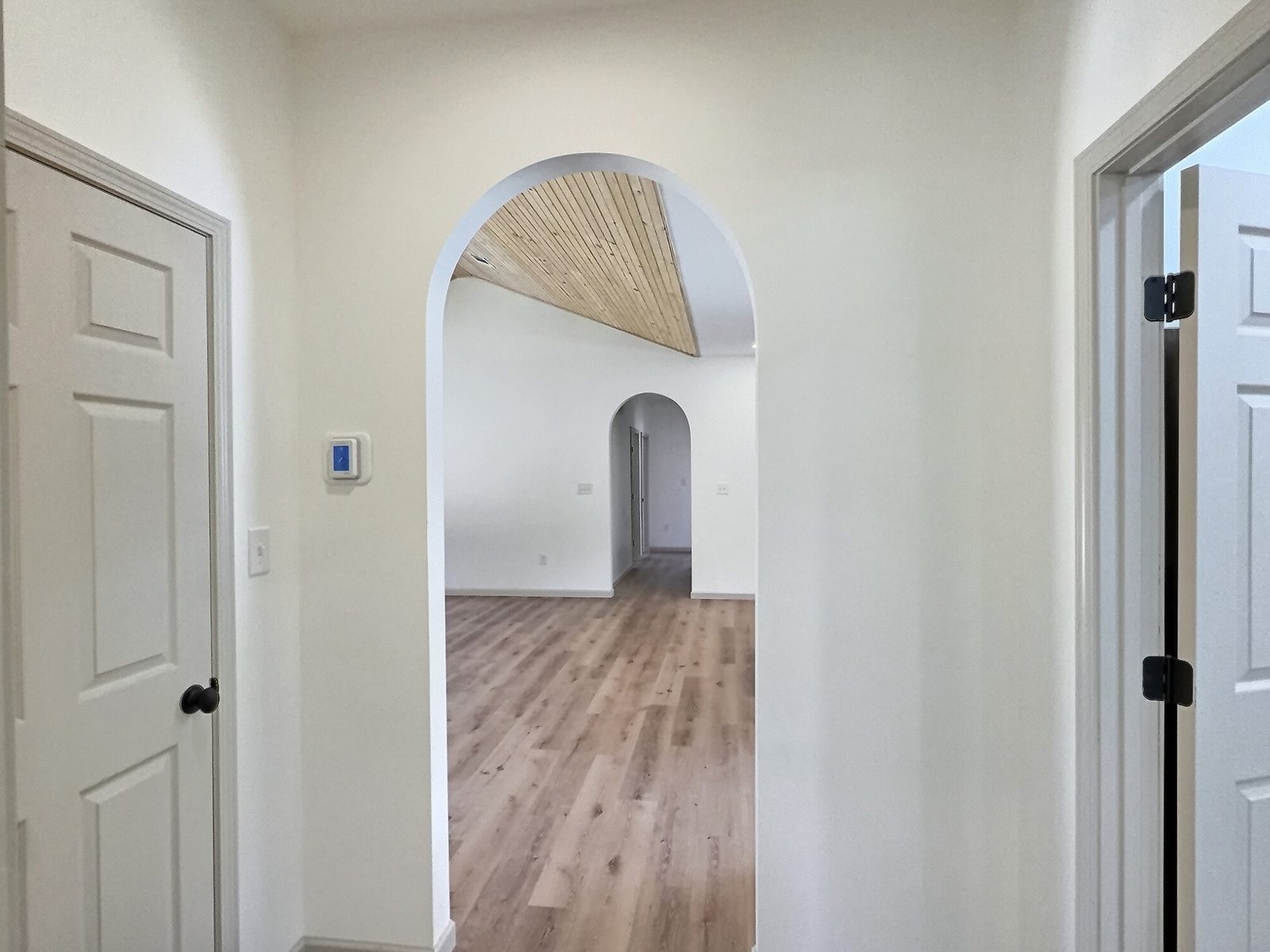 The Cedar Ranch hallway arch looking into the vaulted living room
