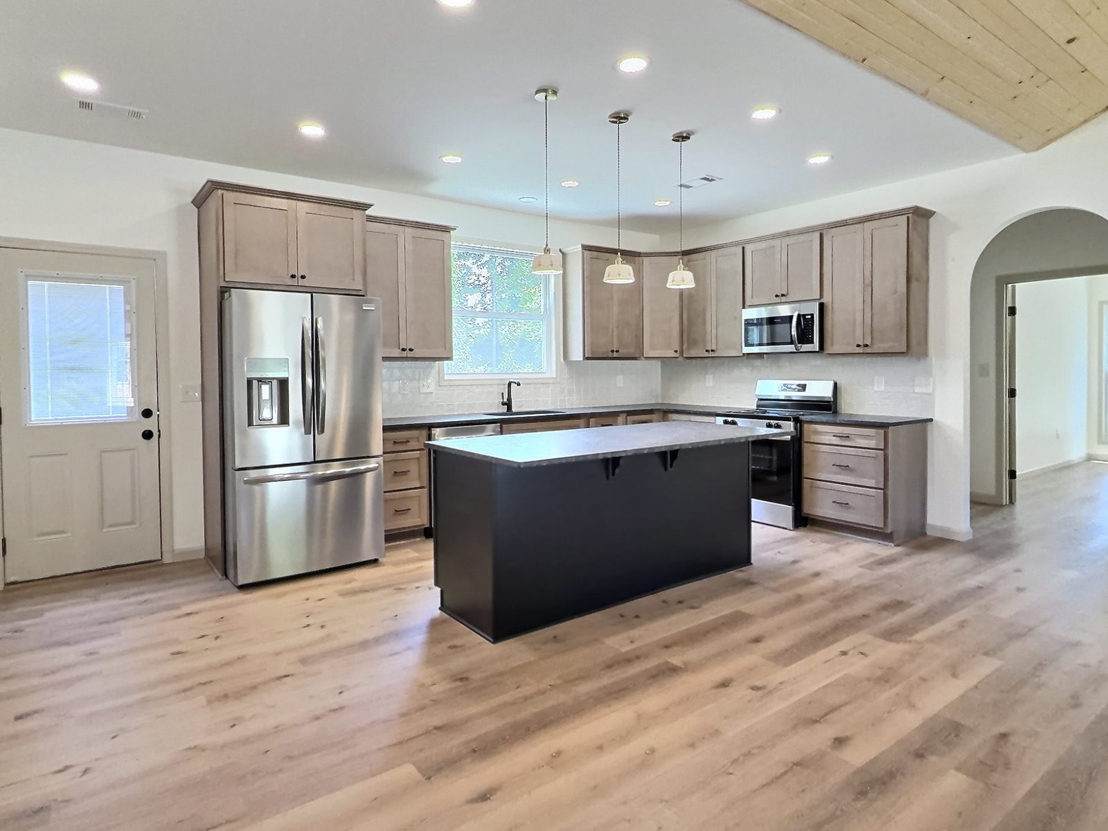 The Cedar Ranch kitchen with island, pendant lights and side door