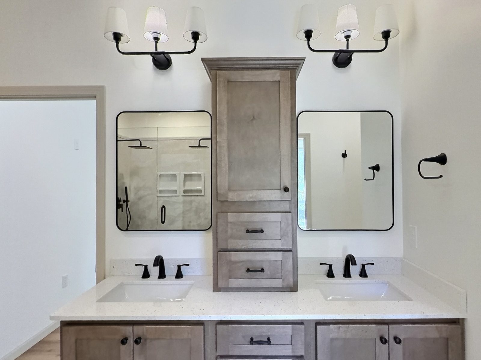 The Cedar Ranch primary bath double vanity with center tower cabinet