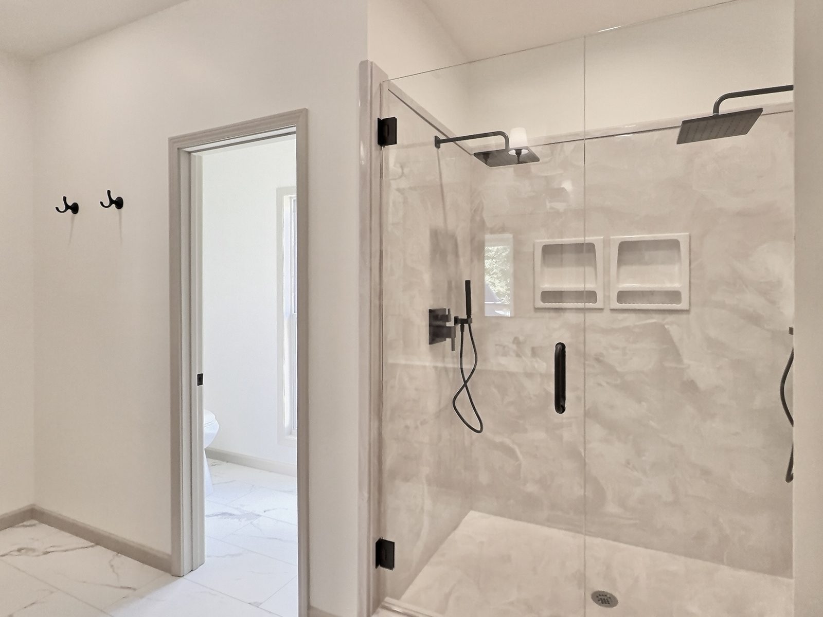 The Cedar Ranch primary bath walk-in shower with dual shower heads
