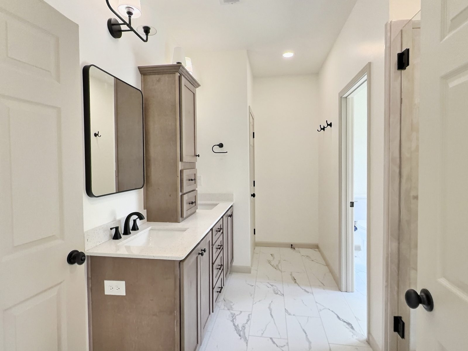 The Cedar Ranch primary bath vanity and linen cabinet