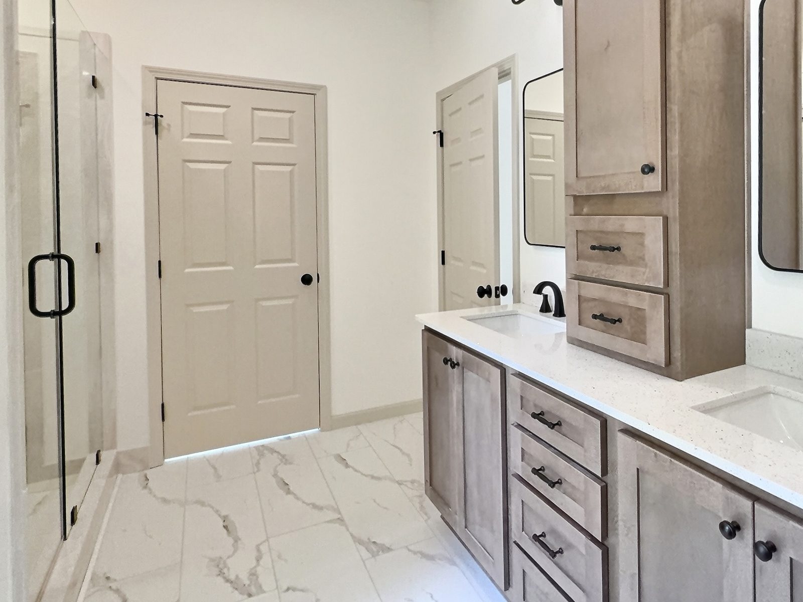 The Cedar Ranch primary bath vanity with marble-look tile floor