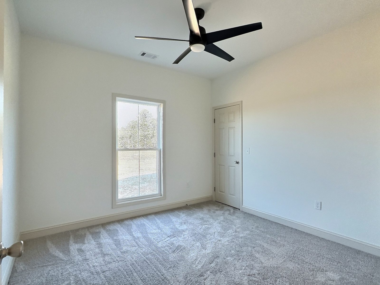 The White Farmhouse carpeted bedroom with window and closet door