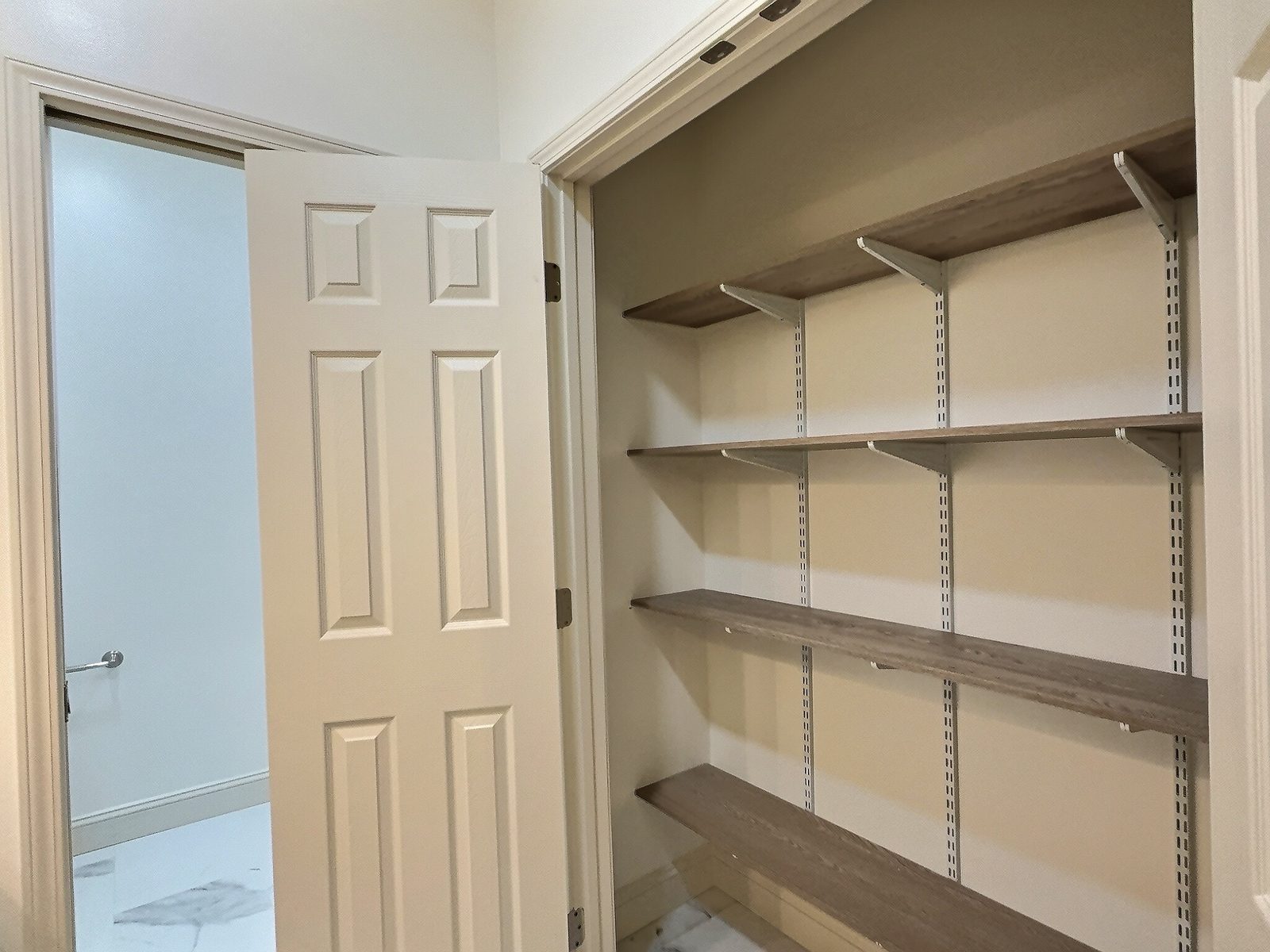 The White Farmhouse walk-in closet with shelving