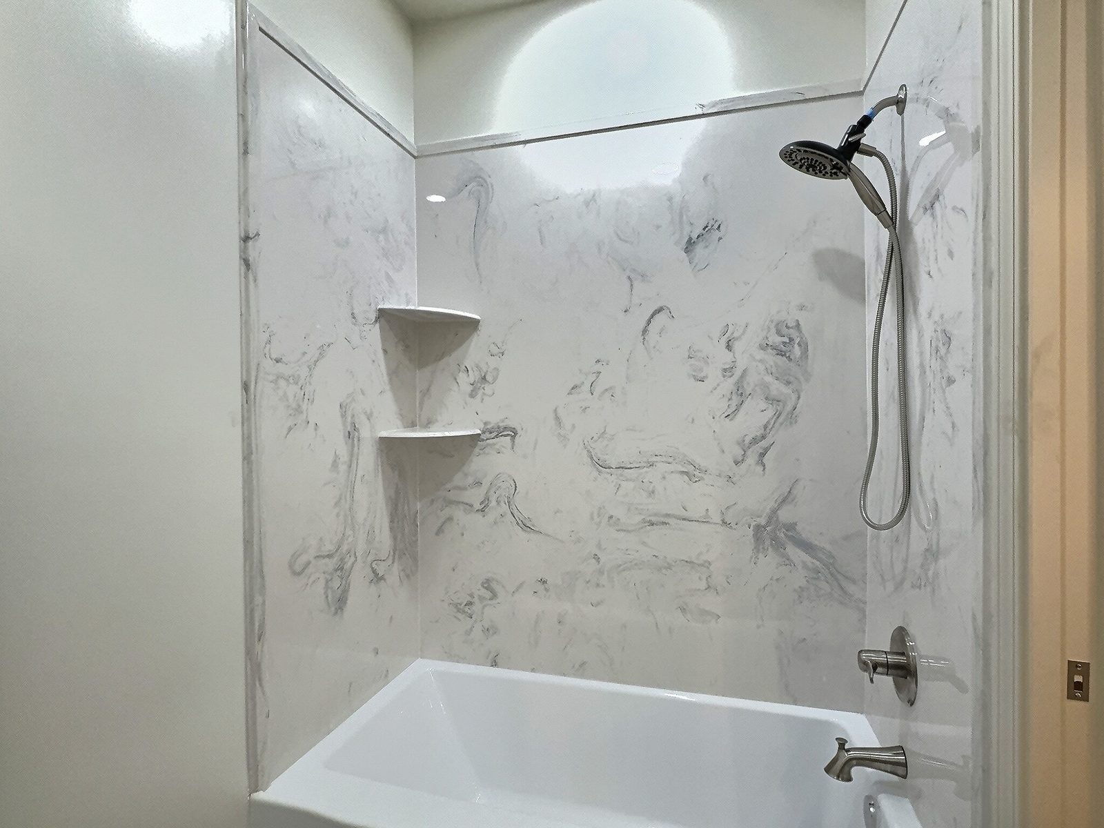 The White Farmhouse hall bath tub and shower