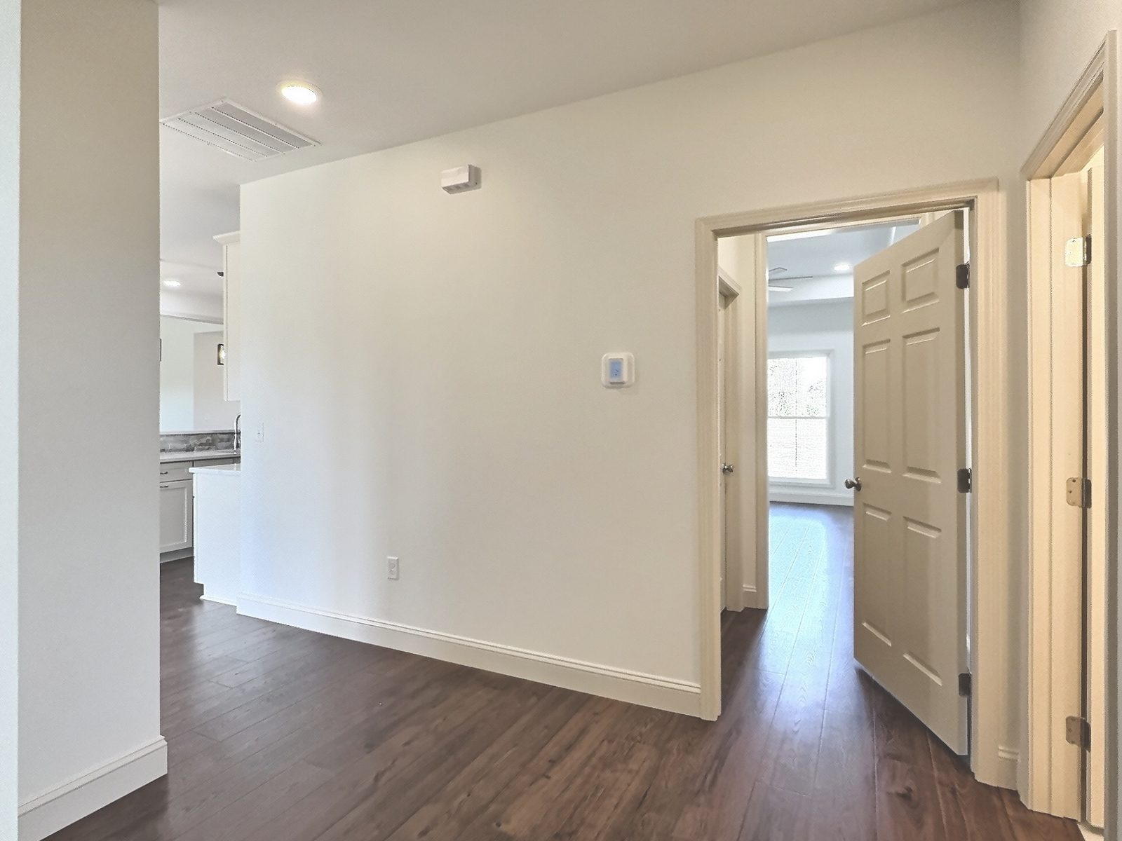 The White Farmhouse hallway with doors to the bedrooms