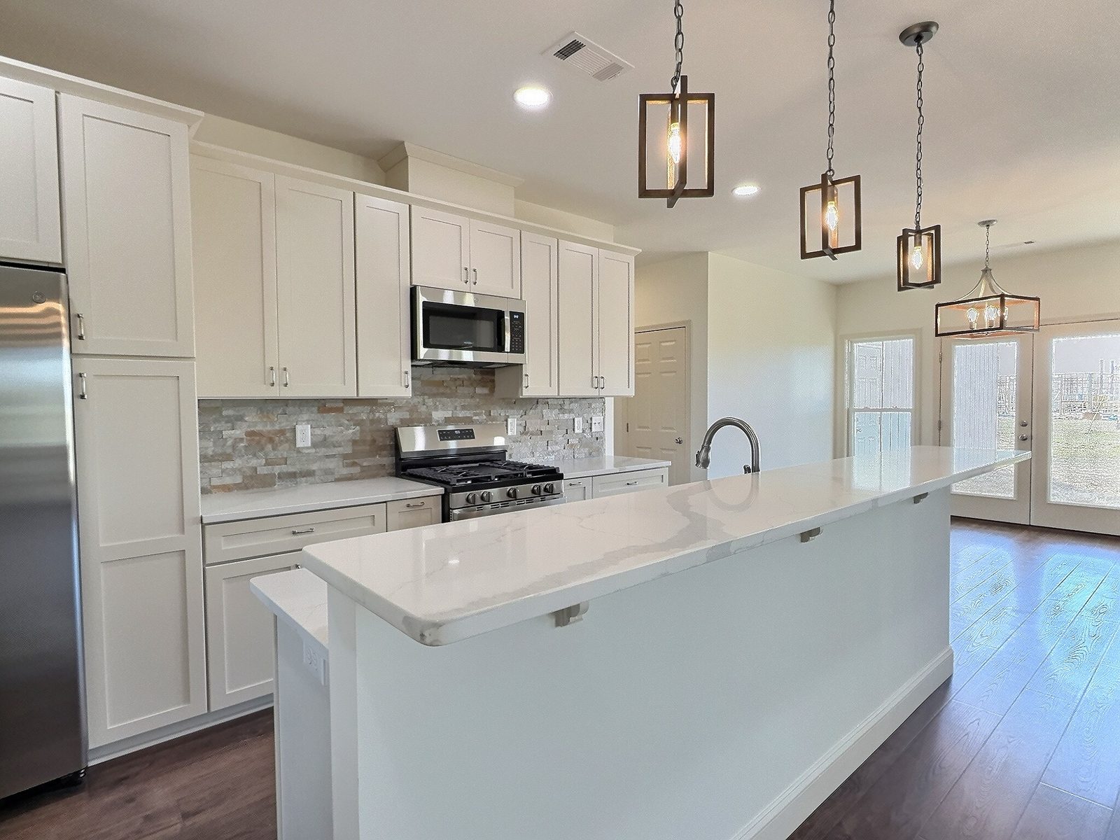The White Farmhouse kitchen island with stainless appliances