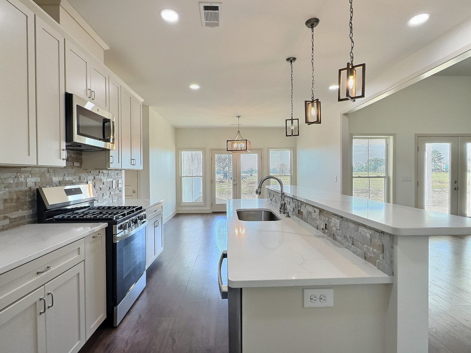The White Farmhouse kitchen with range and pendant lights