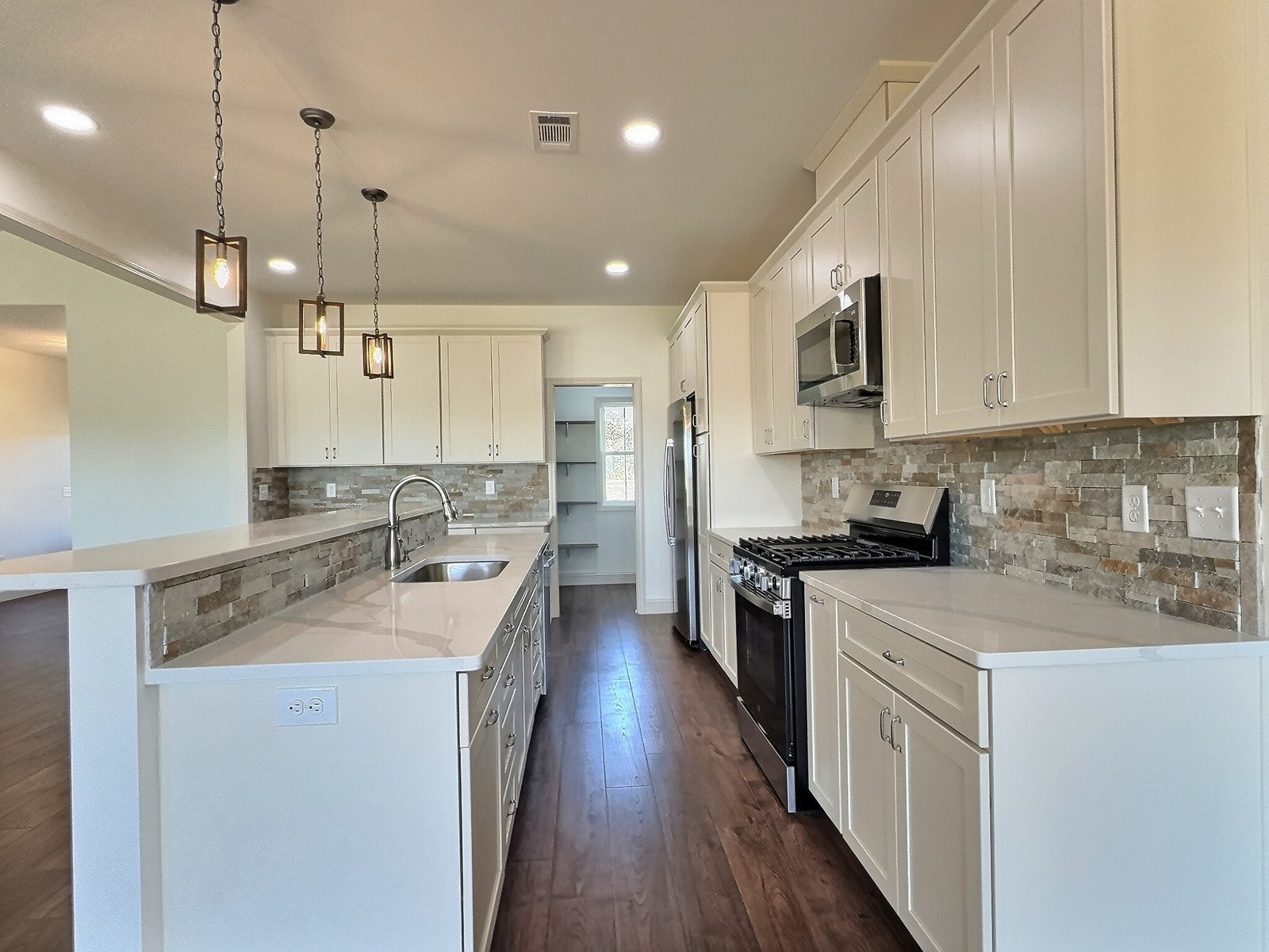 The White Farmhouse kitchen with stone backsplash and range