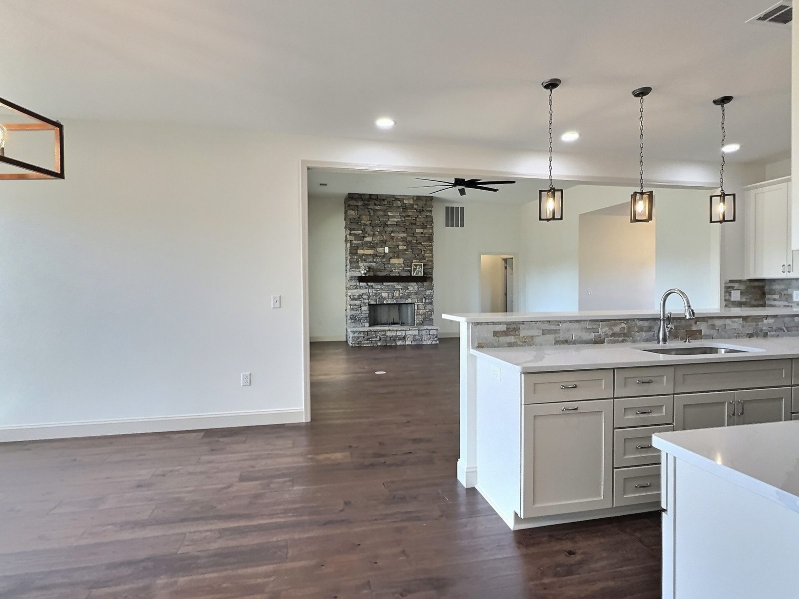 The White Farmhouse kitchen island looking toward the stone fireplace