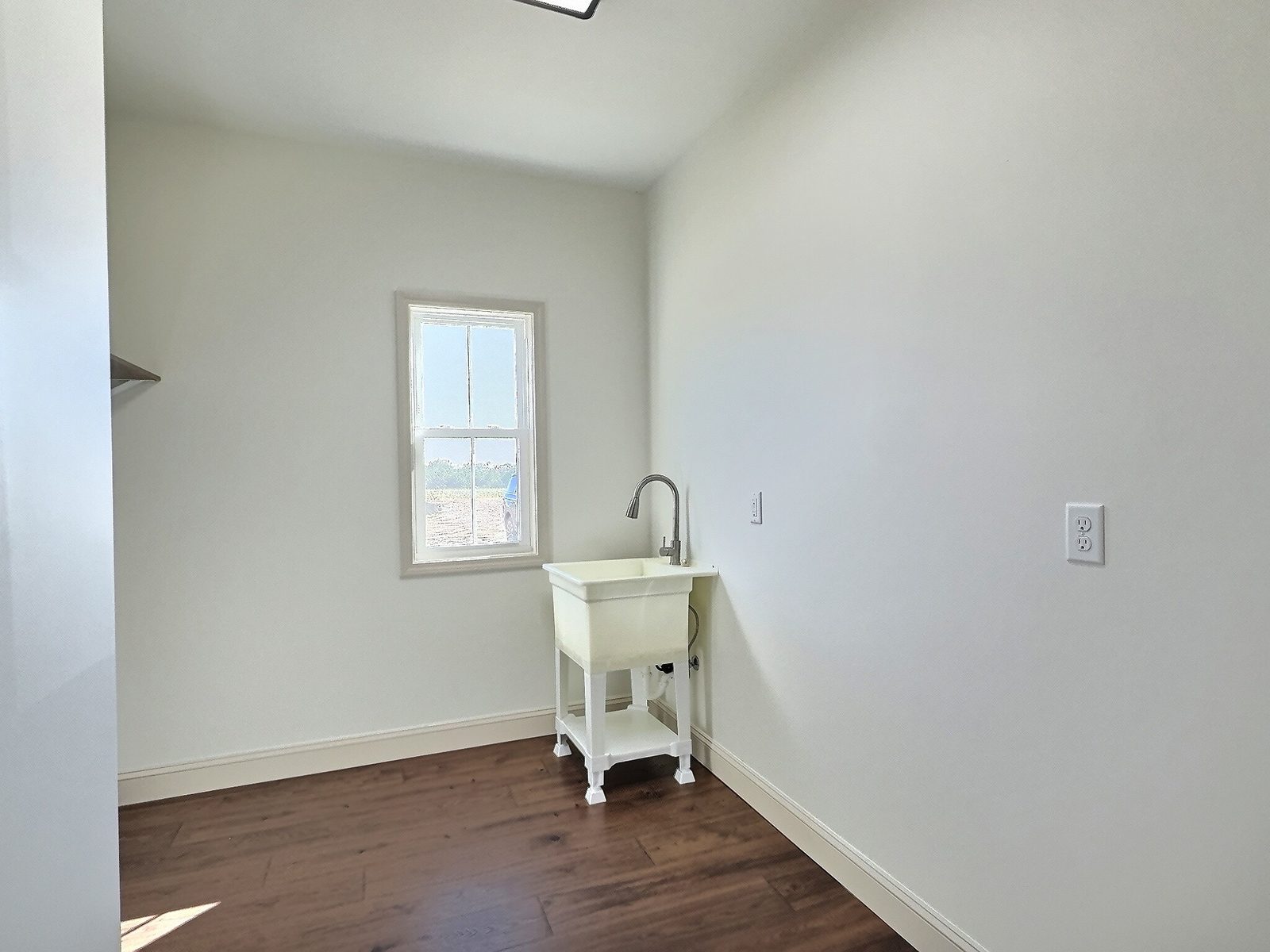 The White Farmhouse laundry room with utility sink