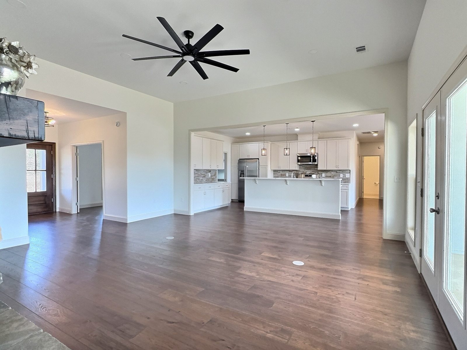 The White Farmhouse living room looking toward the kitchen and hall