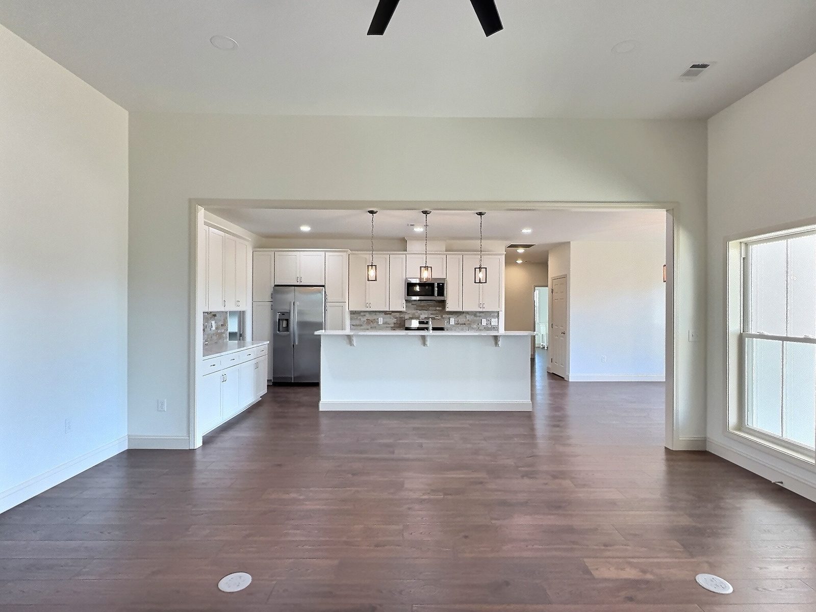 The White Farmhouse living room looking straight into the kitchen