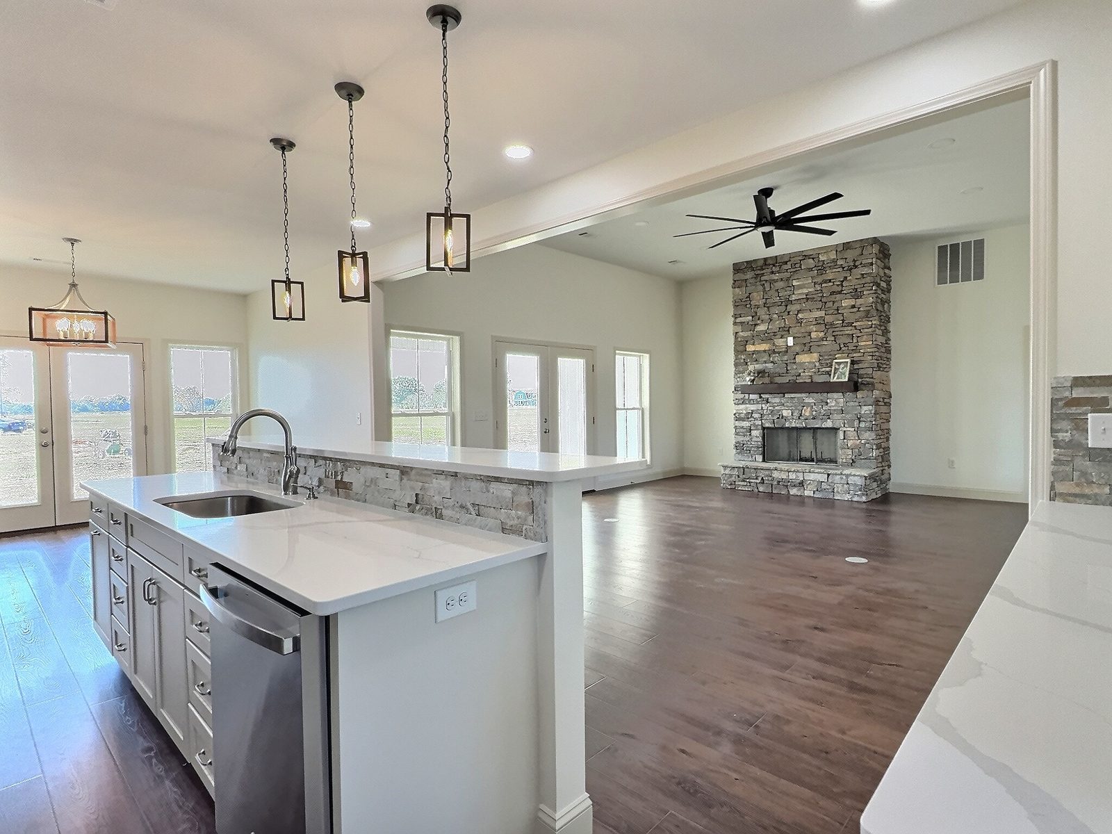 The White Farmhouse kitchen island looking into the living room