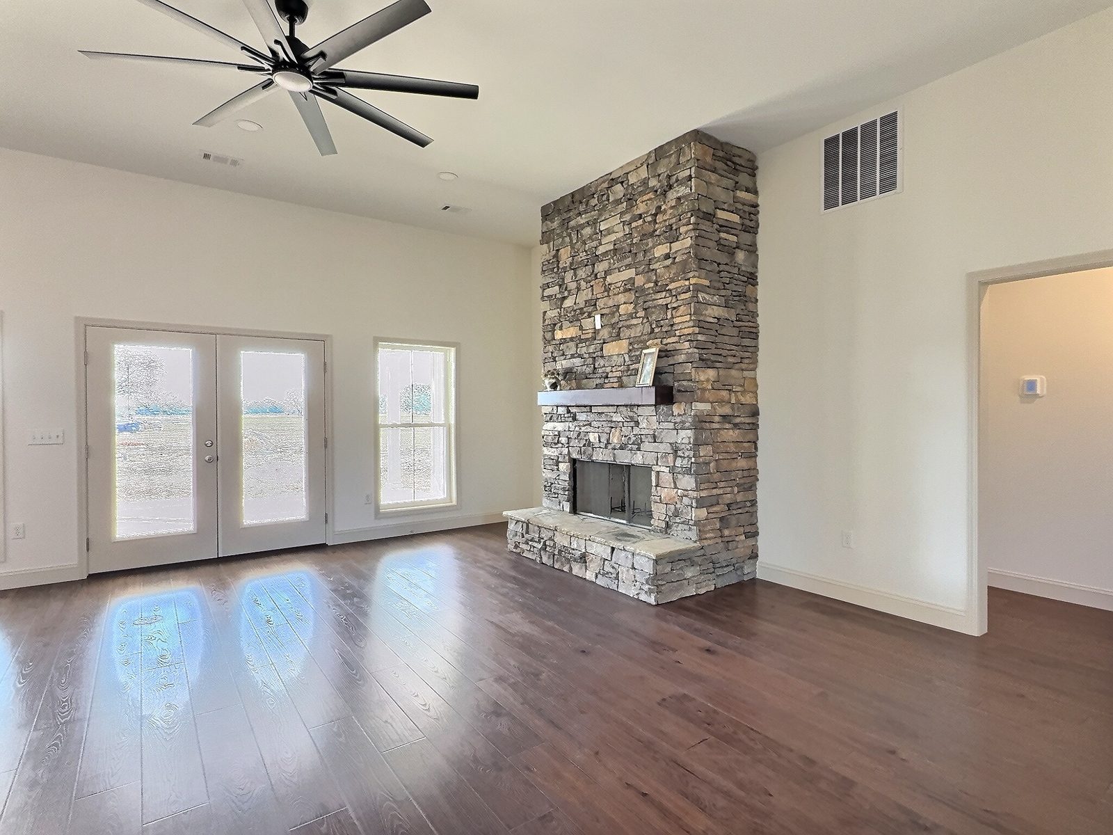 The White Farmhouse stone fireplace and French doors