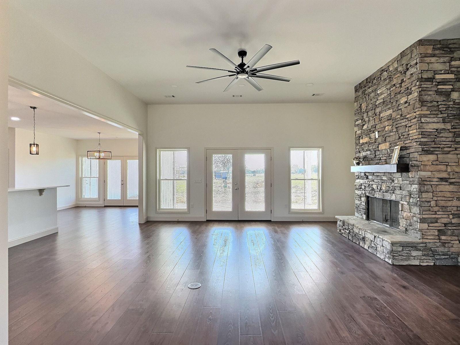 The White Farmhouse living room with floor-to-ceiling stacked stone fireplace
