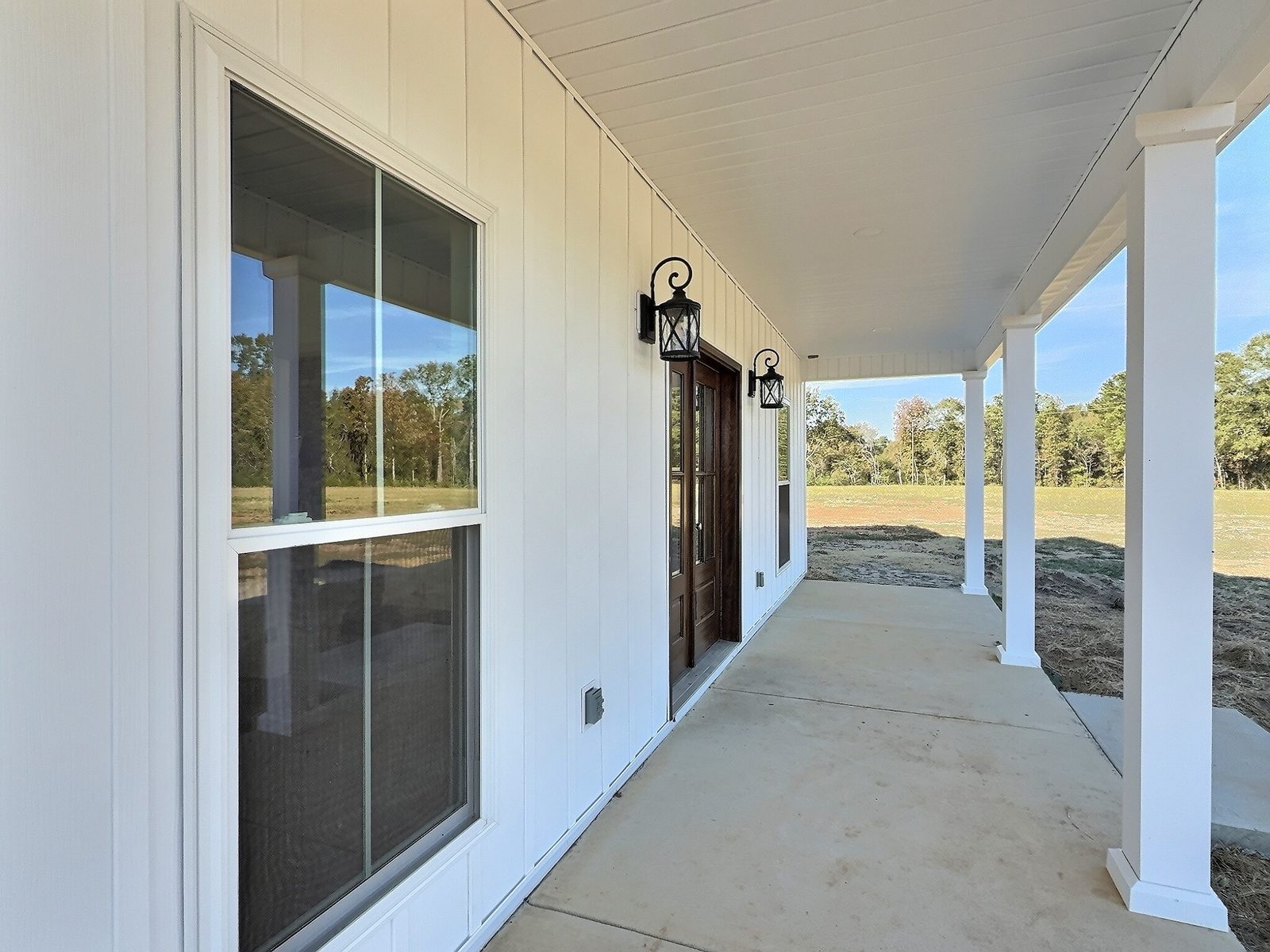 The White Farmhouse covered porch with white columns