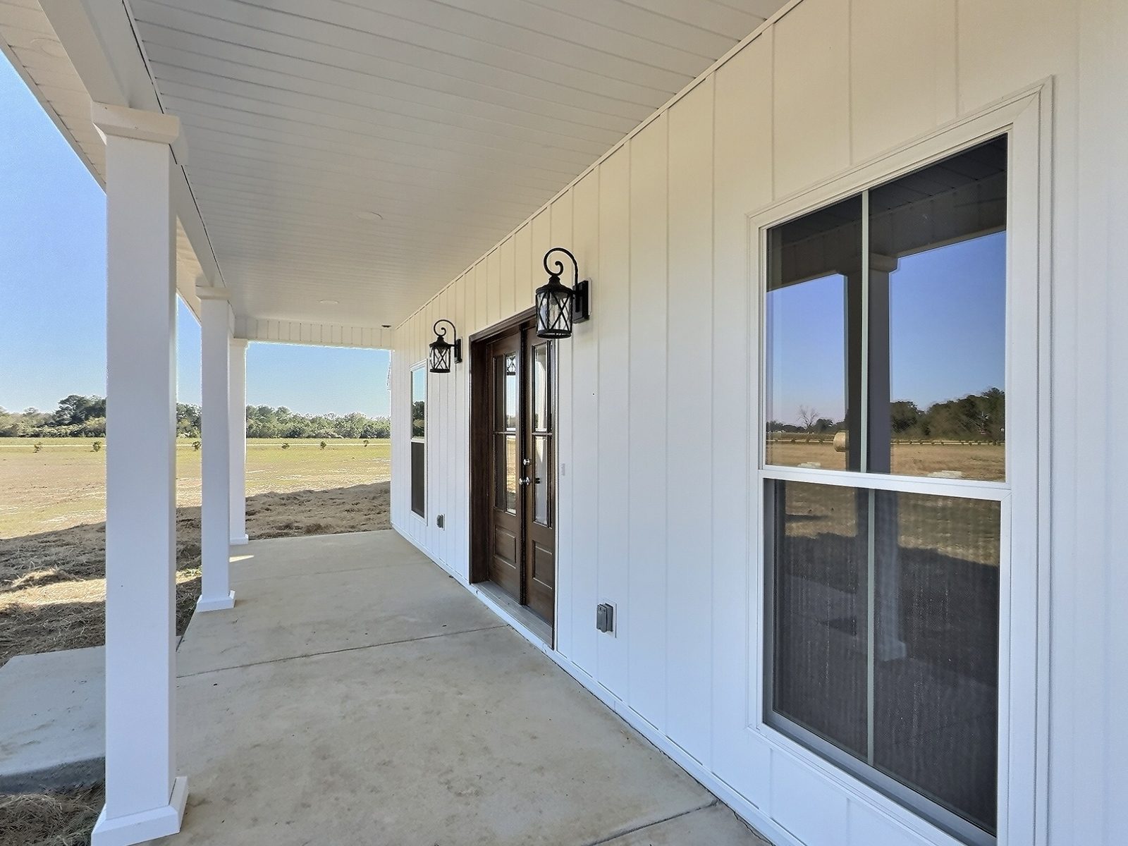The White Farmhouse covered porch looking toward the front doors