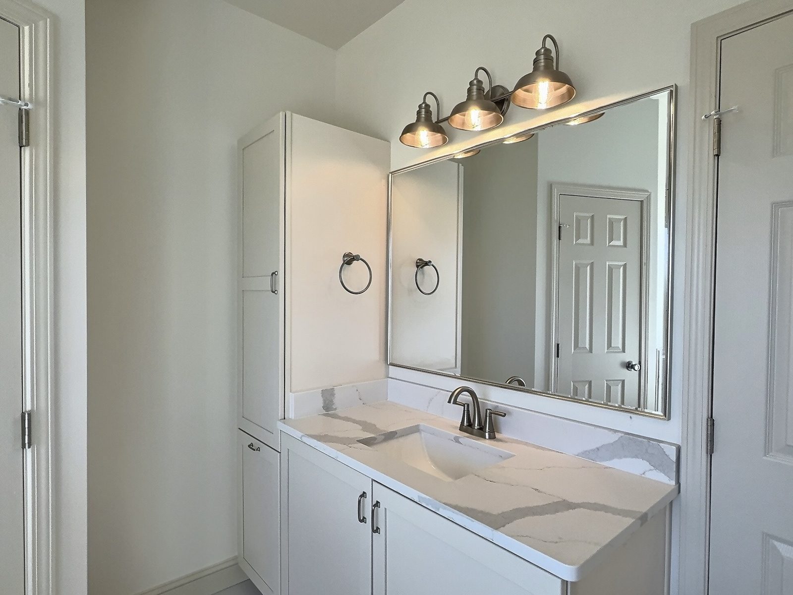 The White Farmhouse primary bath second vanity with linen cabinet